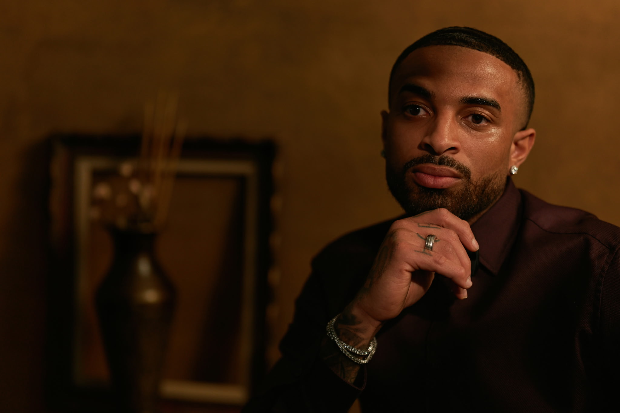 James Muhammad seated in a cinematic portrait